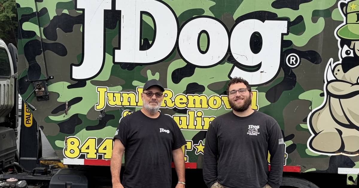 jdog junk removal employees pose by truck