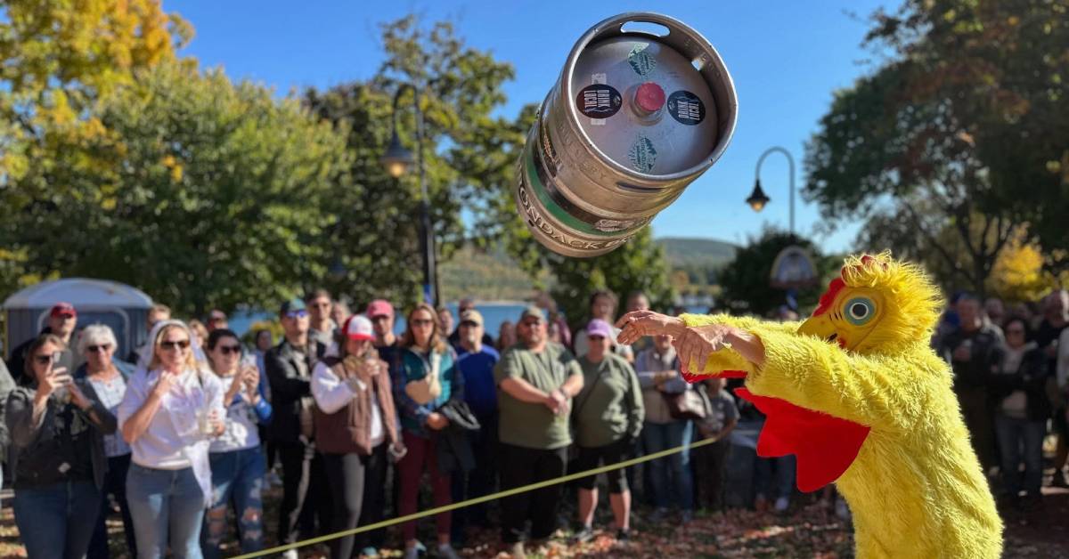 person in chicken costume tossing a keg