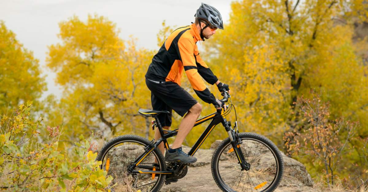 a man riding a mountain bike during fall