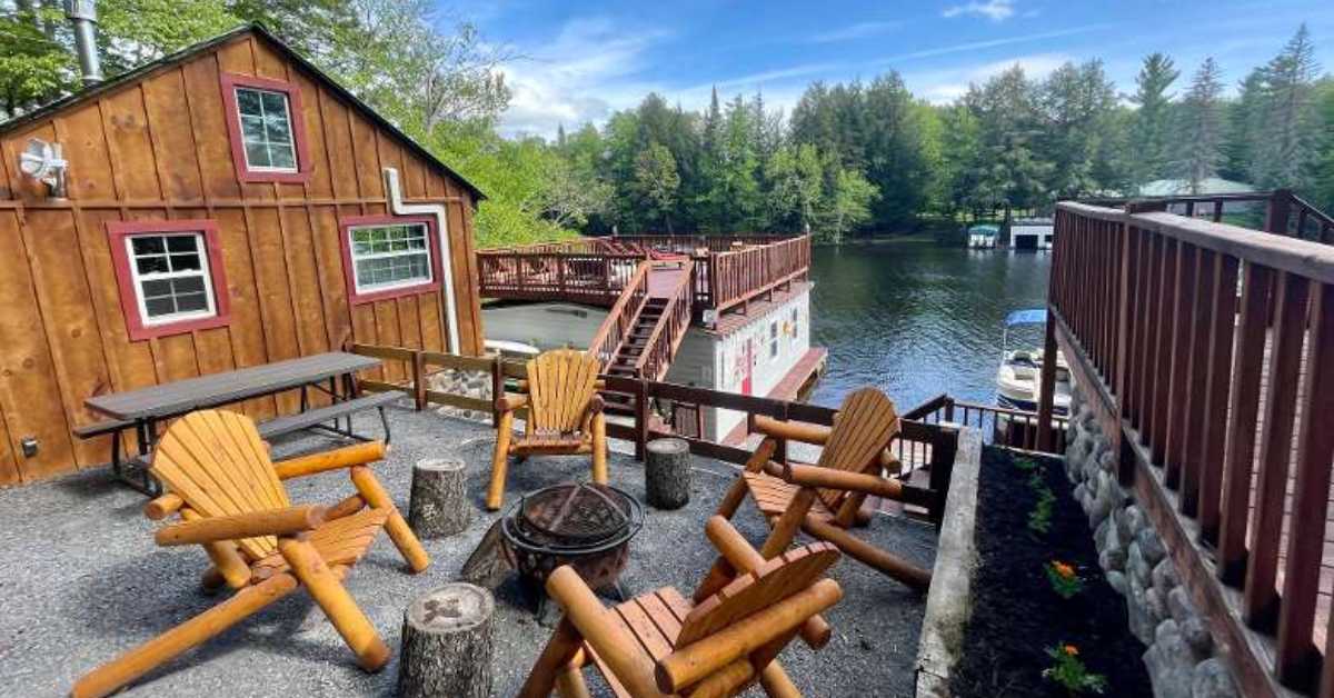 a waterfront cabin property with fire pit by the main building