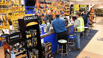 customers at an electrical supply shop's service counter