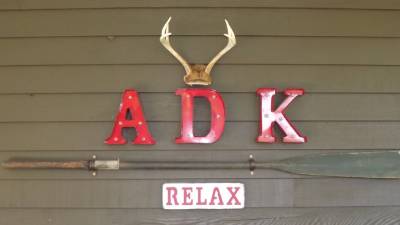 decorative red letters spell out ADK relax