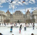 people skating outdoors in front of a city building