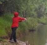 kid in a red hoodie fishes