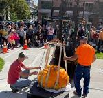group of people at a giant pumpkin weighing contest