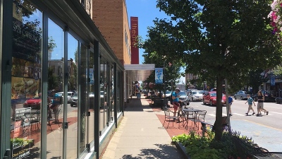 view facing down a street and sidewalk in downtown Glens Falls