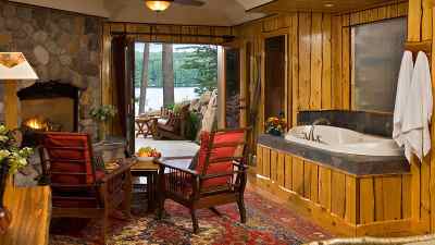 luxury lodging room with hot tub and doors to back deck