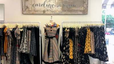 clothing display with caroline and main sign above