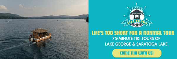 banner advertising tiki tours with a tiki boat floating on lake george