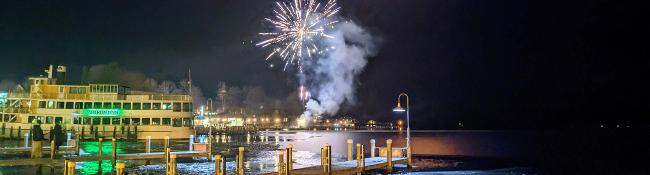fireworks near cruise ship in lake in winter