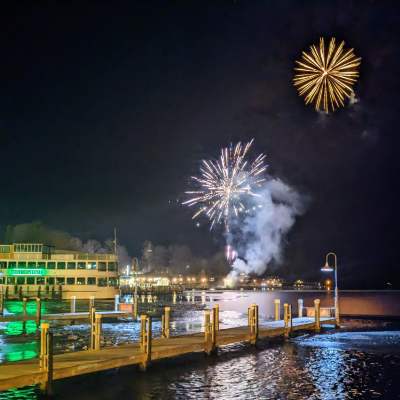 fireworks near cruise ship in lake in winter