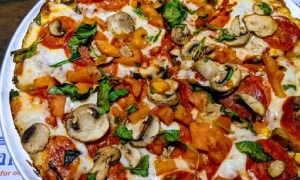 pizza with mushrooms, tomatoes, and basil