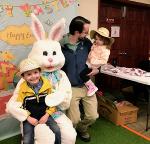 family poses with easter bunny