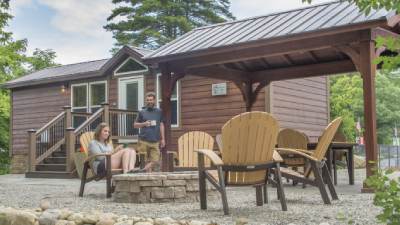 exterior of cabin with couple at fire pit