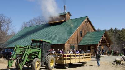 people on a hay wagon ride at a maple farm