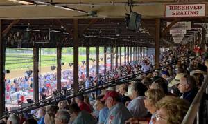 crowd seated in reserved seating at the saratoga race course