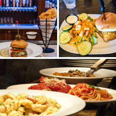 food items from a restaurant with a burger, salad, pasta, etc.