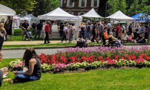vendor tents, flowers, and people at larac arts fest
