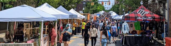 crowd and vendors at art on lark in albany