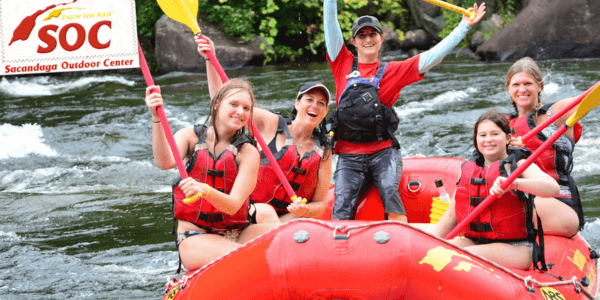Group of Paddlers on a white water rafting tube 