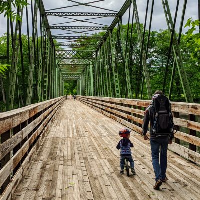 kid and dad walk/hike over a bridge