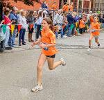 girls running race in orange shirts