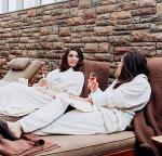 two women chat in robes at the spa