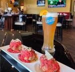 meatballs and beer in restaurant with tvs in background