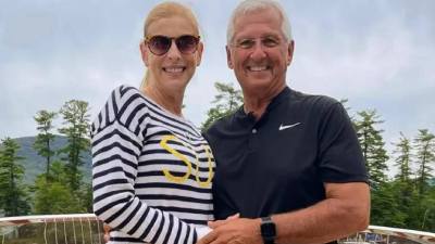 couple poses with lake georgein background