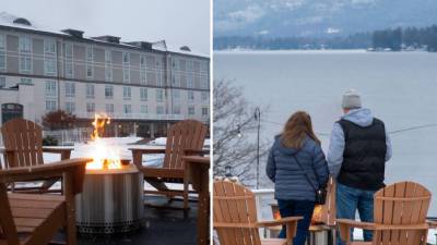 fire pit at fort william henry in winter and people looking out at the lake