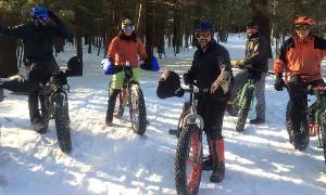 group of people fat tire biking pose