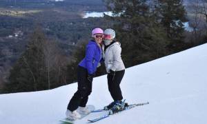 two skiers pose