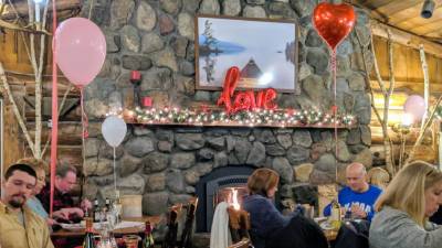 people at restaurant with fireplace on valentine's day