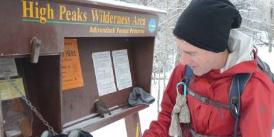 winter hikers at trailhead in high peaks in winter