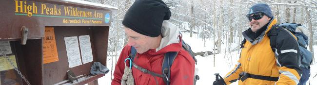 winter hikers at trailhead in high peaks in winter