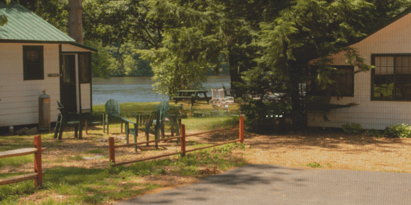 Cabins and chairs along the river at Elms Waterfront Cottages & Lodge