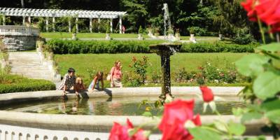 mom and kids look at fountain in yaddo gardens