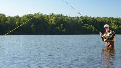 guy in waders fishing