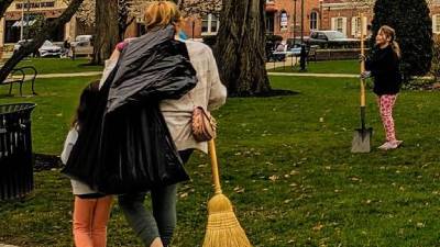 people cleaning up a park for earth day