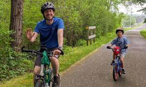 dad and son on biking trail