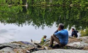 hikers relax by a lake