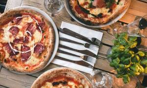 pizza and basil on table