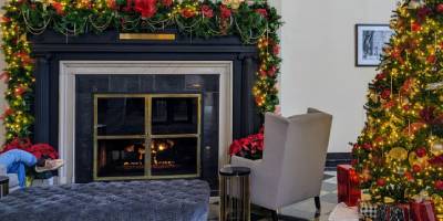 queensbury hotel lobby fireplace and tree decorated for christmas