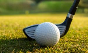 golf club against golf ball