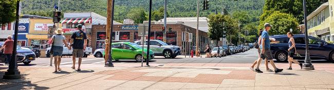 people walking through lake george village