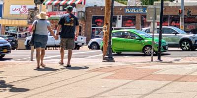 people walking through lake george village
