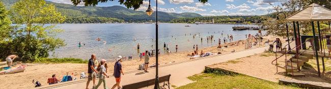 people walking by lake george beach