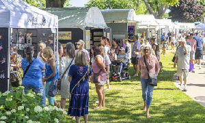 people walking around an art fair