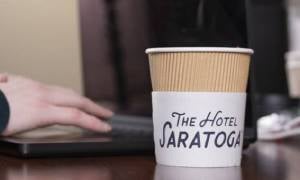 hotel saratoga coffee cup by computer