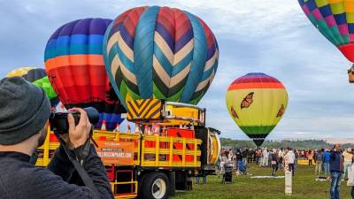 man takes photos with camera at adirondack balloon festival